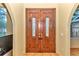 Elegant double front door with decorative glass inserts and ornate wood detailing at 19057 Sw 98Th Loop, Dunnellon, FL 34432