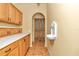 Hallway featuring stylish cabinetry, a unique sink, and ornate wooden doors at 19057 Sw 98Th Loop, Dunnellon, FL 34432