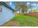 Expansive backyard featuring lush green grass, mature trees and a privacy fence at 5721 Se 22Nd Pl, Ocala, FL 34480