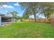 Large backyard with a well-maintained lawn, perfect for outdoor activities and relaxation at 5721 Se 22Nd Pl, Ocala, FL 34480