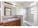Bathroom featuring a vanity, sink, and a tiled walk-in shower at 5721 Se 22Nd Pl, Ocala, FL 34480