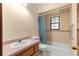 Bathroom featuring a vanity, toilet, and shower-tub combo at 5721 Se 22Nd Pl, Ocala, FL 34480