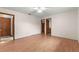 Bedroom with wood floors, ceiling fan, and multiple doorways at 5721 Se 22Nd Pl, Ocala, FL 34480