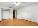 Bedroom with fan, wood floors, and access to closet and hallway at 5721 Se 22Nd Pl, Ocala, FL 34480