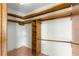 Walk-in closet with wood shelving and ample storage space at 5721 Se 22Nd Pl, Ocala, FL 34480