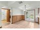 Dining area featuring tile flooring, wood paneling, and French doors at 5721 Se 22Nd Pl, Ocala, FL 34480
