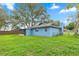 Exterior view of the home features a screened-in porch and a large backyard at 5721 Se 22Nd Pl, Ocala, FL 34480