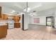 Open-concept kitchen flowing into living area with tile floors and natural light at 5721 Se 22Nd Pl, Ocala, FL 34480