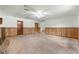 Spacious room with paneled walls and brick fireplace ready for renovation at 5721 Se 22Nd Pl, Ocala, FL 34480