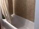 Clean bathroom with shower/tub combo and tile surround at 6340 Se 127Th Pl, Belleview, FL 34420
