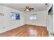 Bedroom with laminate flooring, ceiling fan, and two windows at 6521 Sw 108Th St, Ocala, FL 34476