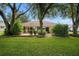 View of home's backyard with patio and lush landscaping at 2398 Nw 50Th Ave, Ocala, FL 34482