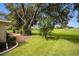 Landscaped backyard with lush lawn and mature trees at 2398 Nw 50Th Ave, Ocala, FL 34482