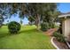 Landscaped backyard with mature trees and golf course view at 2398 Nw 50Th Ave, Ocala, FL 34482