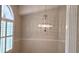 Formal dining room featuring a chandelier and a large window with shutters at 2398 Nw 50Th Ave, Ocala, FL 34482