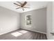 A bright bedroom with a ceiling fan and wood-look flooring at 4030 Se 134Th St, Belleview, FL 34420