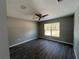 Bedroom with large window, vinyl flooring, and ceiling fan at 4030 Se 134Th St, Belleview, FL 34420