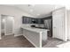 Kitchen featuring stainless steel appliances, dark cabinets, and sleek granite countertops at 4030 Se 134Th St, Belleview, FL 34420