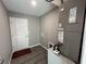 Bright laundry room with vinyl flooring, door, and HVAC unit at 4030 Se 134Th St, Belleview, FL 34420