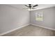 Well-lit bedroom with ceiling fan and hardwood floors at 5761 Ne 4Th Pl, Ocala, FL 34470