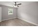 Well-lit bedroom with ceiling fan and hardwood floors at 5761 Ne 4Th Pl, Ocala, FL 34470