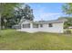 House exterior showcasing a newly painted white exterior and a large backyard at 5761 Ne 4Th Pl, Ocala, FL 34470