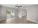 Bright living room featuring hardwood floors and sliding glass doors leading to a patio at 5761 Ne 4Th Pl, Ocala, FL 34470