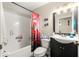 Bathroom with shower/tub combo and dark vanity at 6990 Se 122Nd Ln, Belleview, FL 34420