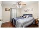 Bright bedroom with a ceiling fan and wood-look floors at 6990 Se 122Nd Ln, Belleview, FL 34420