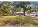 House with a spacious yard, large tree, and driveway at 6990 Se 122Nd Ln, Belleview, FL 34420