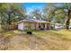 Tan house with a yard, and wood fence at 6990 Se 122Nd Ln, Belleview, FL 34420