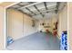 Empty garage with open door and concrete floor at 6990 Se 122Nd Ln, Belleview, FL 34420