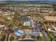 Aerial view of SummerGlen community featuring golf course, tennis courts, community pool, clubhouse and single Gathering homes at 16369 Sw 14Th Avenue Rd, Ocala, FL 34473