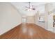 Spacious living room with hardwood floors, ceiling fan, and an open concept layout that leads to dining area and kitchen at 16369 Sw 14Th Avenue Rd, Ocala, FL 34473