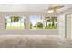 Bright sun room featuring tile floors, multiple windows offering views of the well maintained backyard, and a ceiling fan at 16369 Sw 14Th Avenue Rd, Ocala, FL 34473