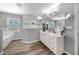 Open-concept bathroom featuring a soaking tub, tiled shower, and double vanity, designed for relaxation and convenience at 1934 Nw 79Th Loop, Ocala, FL 34475