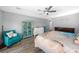 Bright bedroom with a ceiling fan, comfortable seating, and a coastal-themed decor, creating a relaxing atmosphere at 1934 Nw 79Th Loop, Ocala, FL 34475
