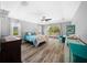 Bright bedroom features wood floors, a ceiling fan, and sliding glass doors to the pool area at 1934 Nw 79Th Loop, Ocala, FL 34475