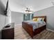 Bedroom featuring a ceiling fan, laminate flooring, and window with curtains at 1934 Nw 79Th Loop, Ocala, FL 34475