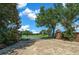 Brick entrance with iron gates, mature trees, landscaping, and brick paved drive welcome you to the property at 1934 Nw 79Th Loop, Ocala, FL 34475