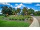 The Irish Acres community sign is surrounded by lush green landscaping under a sunny blue sky at 1934 Nw 79Th Loop, Ocala, FL 34475