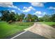 Landscaped community entrance with mature trees and manicured lawns lead to the welcoming Irish Acres sign at 1934 Nw 79Th Loop, Ocala, FL 34475