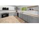 Kitchen with white subway tile backsplash, gray cabinets, stainless steel appliances, and granite countertops at 1934 Nw 79Th Loop, Ocala, FL 34475