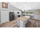 Modern kitchen featuring a large island, stainless steel appliances, and sleek white and gray cabinets at 1934 Nw 79Th Loop, Ocala, FL 34475