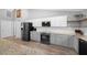 Modern kitchen featuring stainless steel appliances, light grey cabinets, and granite countertops at 1934 Nw 79Th Loop, Ocala, FL 34475