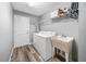 Well-lit laundry room with modern appliances, practical sink, and functional shelving for supplies at 1934 Nw 79Th Loop, Ocala, FL 34475