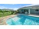 Inviting pool with tiled steps and lush landscaping, creating a serene backyard oasis at 1934 Nw 79Th Loop, Ocala, FL 34475