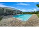 Sparkling pool with a brick-paved deck, offering a peaceful retreat in the backyard at 1934 Nw 79Th Loop, Ocala, FL 34475