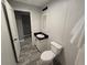 Well-lit bathroom features a modern vanity with black countertop, mirror, and toilet at 3174 Sw 189Th Ave, Dunnellon, FL 34432