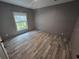 Bright, airy bedroom with wood-look flooring and natural light from the window at 3174 Sw 189Th Ave, Dunnellon, FL 34432